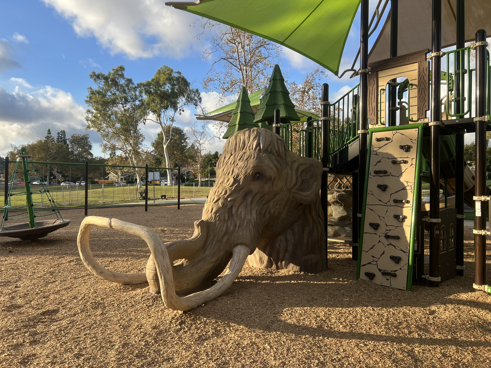 Close-up of the 7-foot mammoth head at Acacia Park, part of the Fullerton playground installation