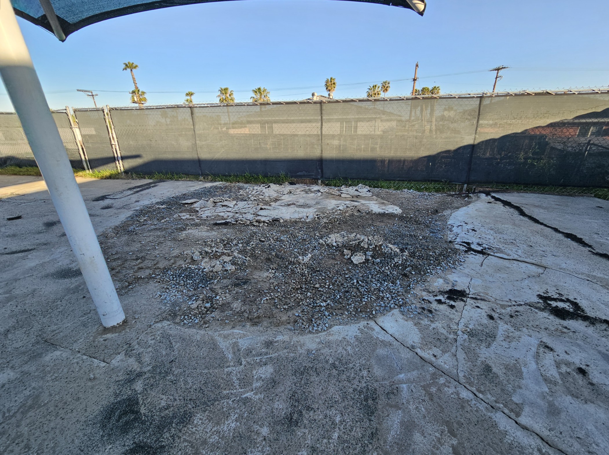 Damaged concrete uncovered during the church playground installation at Adventure Point Early Learning Center, prior to new rubber surfacing.