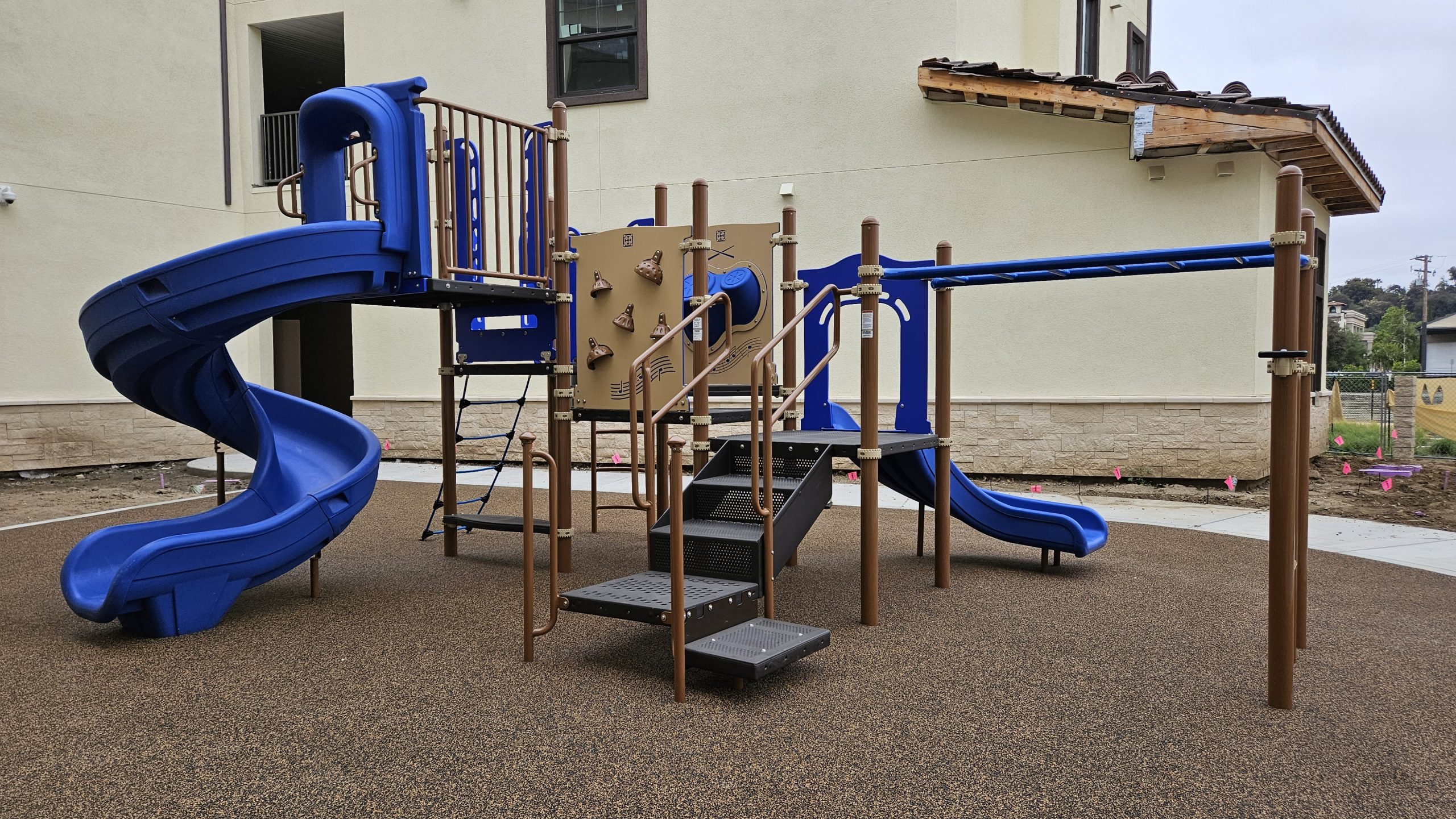 Full view of Pacific Play Systems’ apartment playground installation at Vine Creek Apartments in Riverside County, showing slides, monkey bars, and climbing structures.