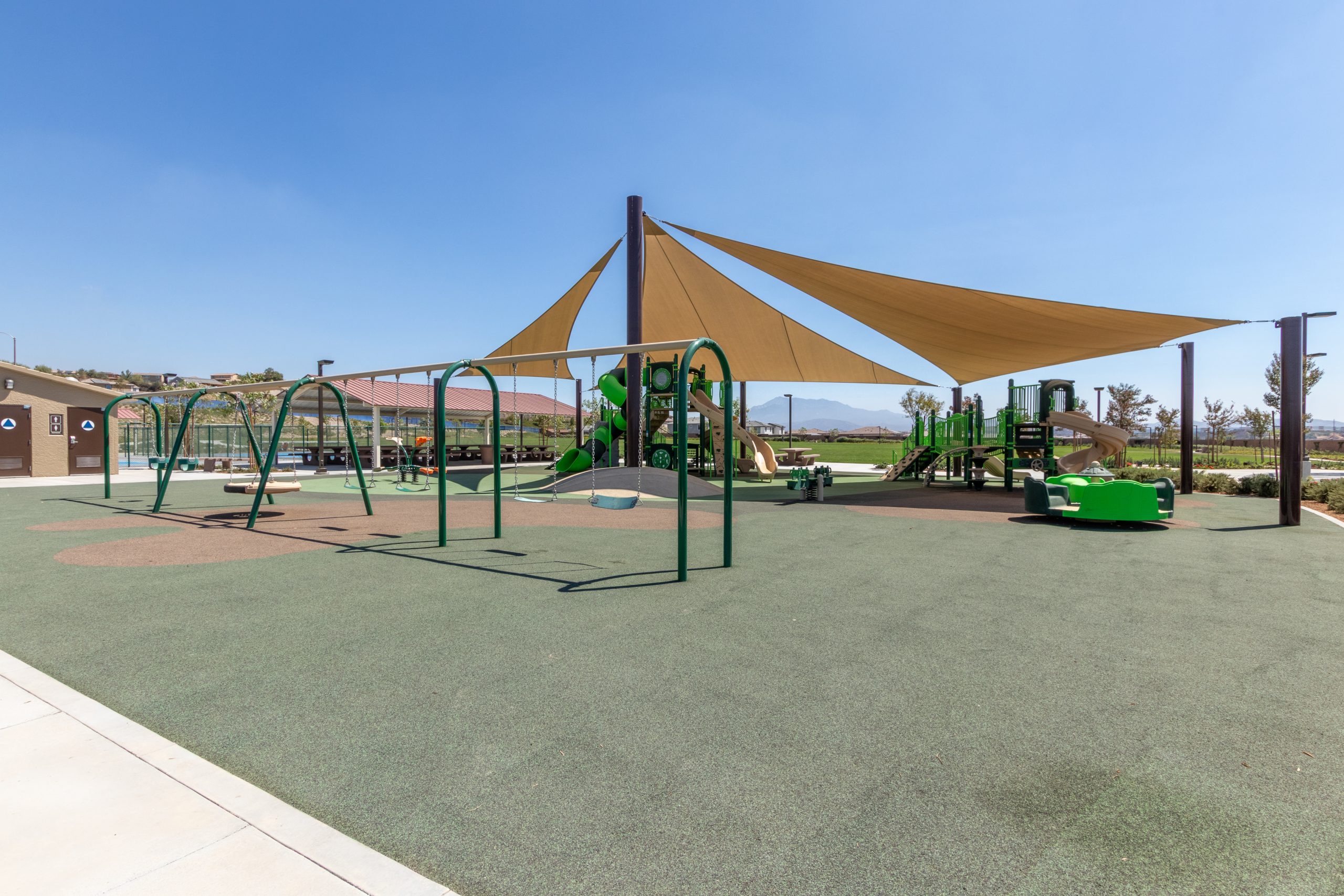 Close-up of the swing set area installed as part of Pacific Play Systems’ commercial playground installation at Fairway Canyon Park in Riverside County.