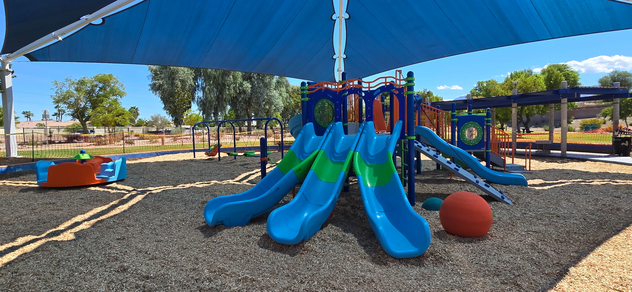 Colorful slides at Adams Park playground in La Quinta, designed and installed by Pacific Play Systems for safe, active play.