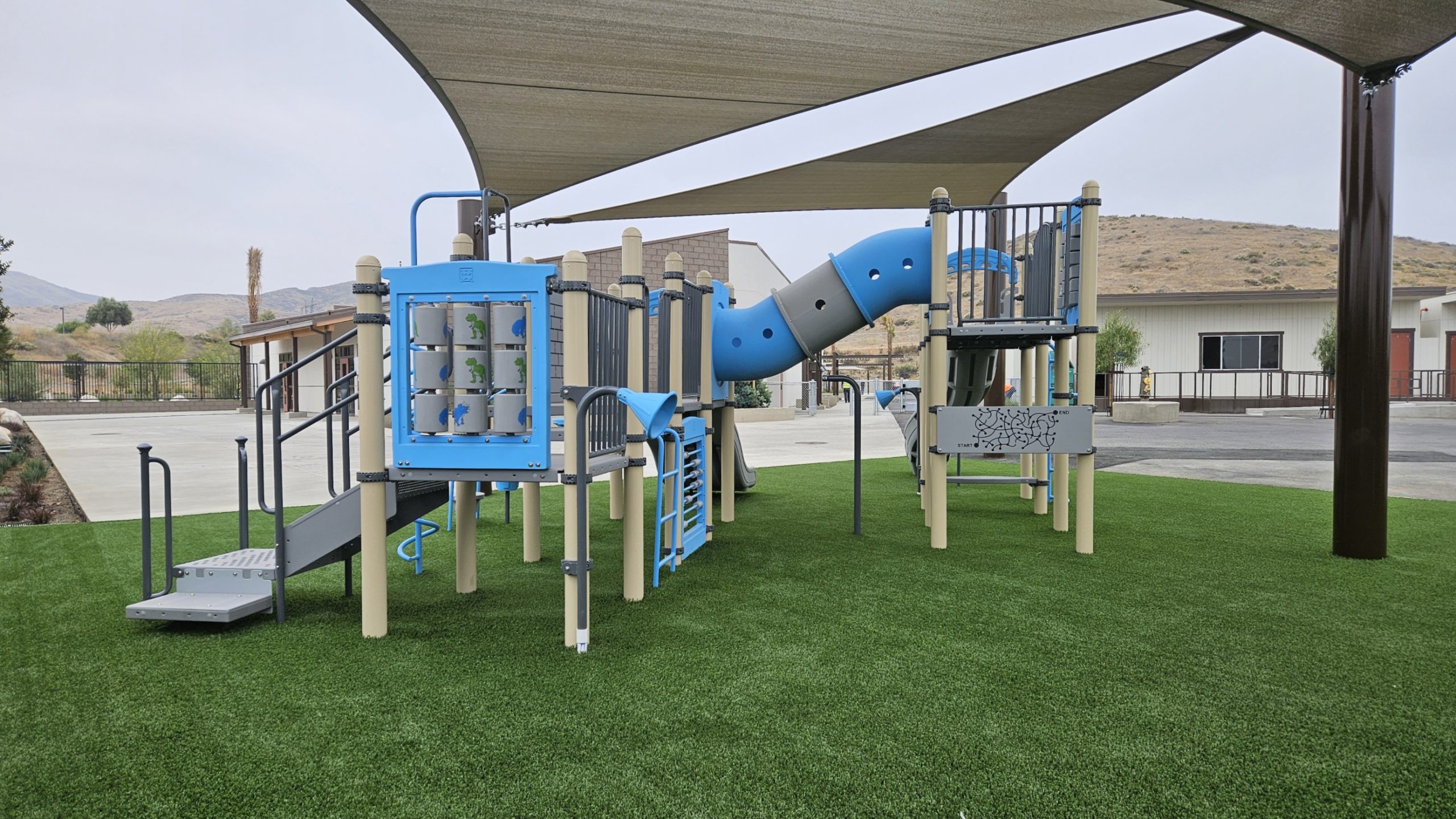 Ground-level interactive panels and play components in a school playground installation at Granite Hills TK-8